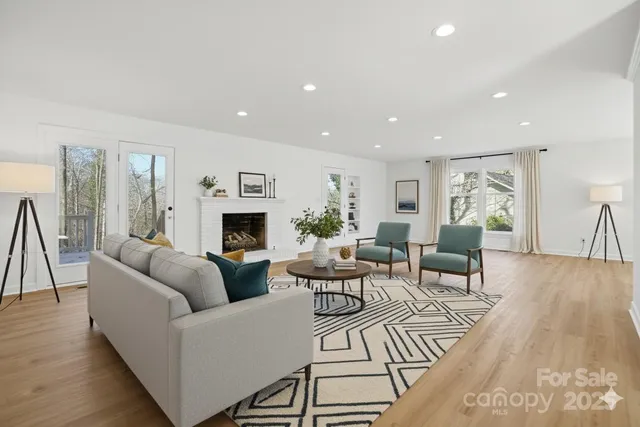 a view of an empty room with wooden floor and cabinet