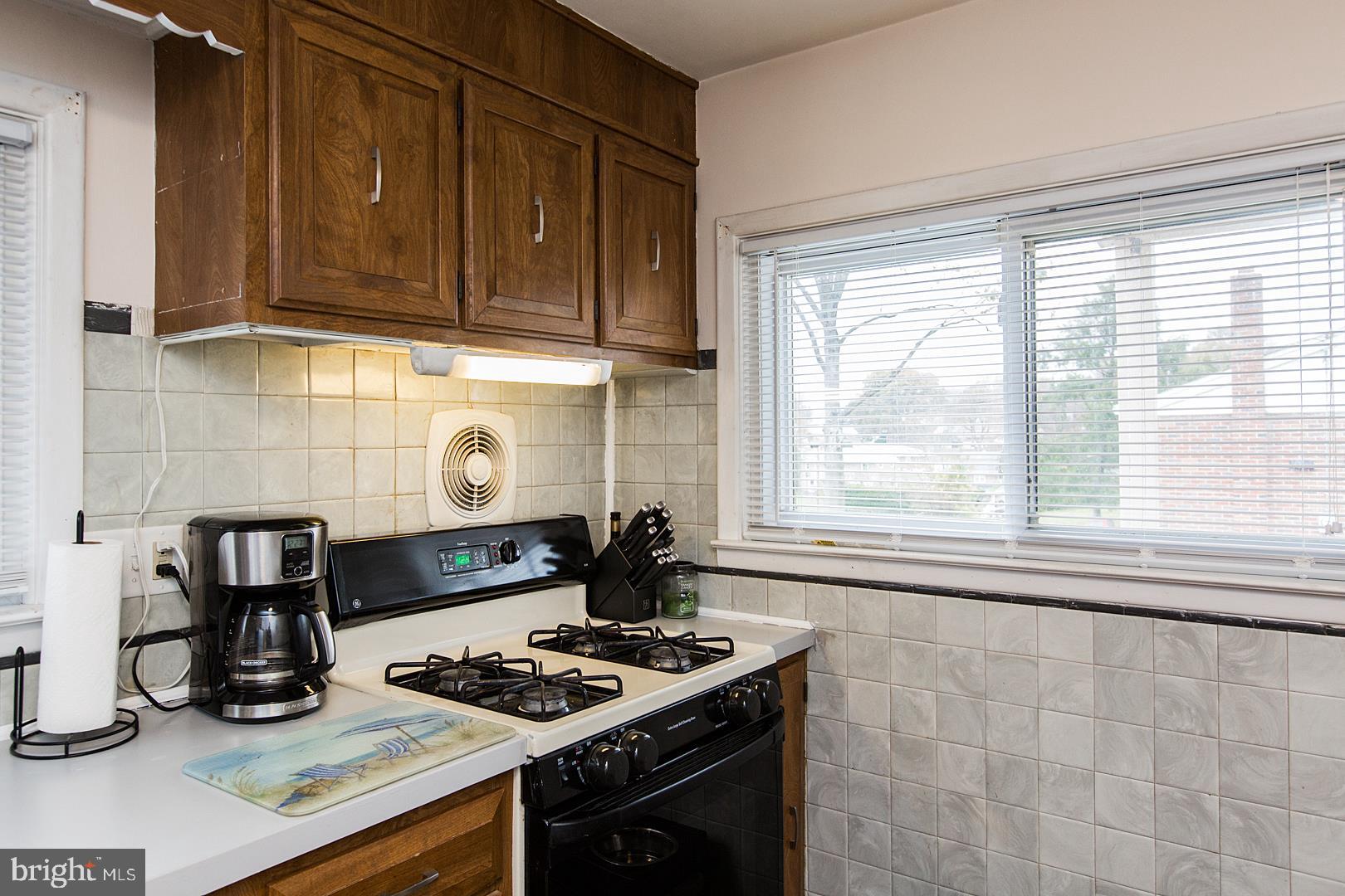 3720 Rosewood Road Reading, PA 19605 - Photo 22 of 56 a kitchen with a stove and a wooden cabinets