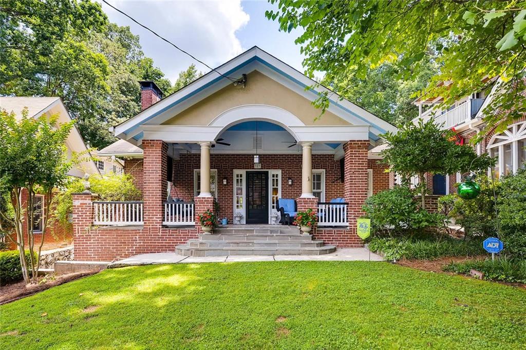 a front view of a house with garden and porch