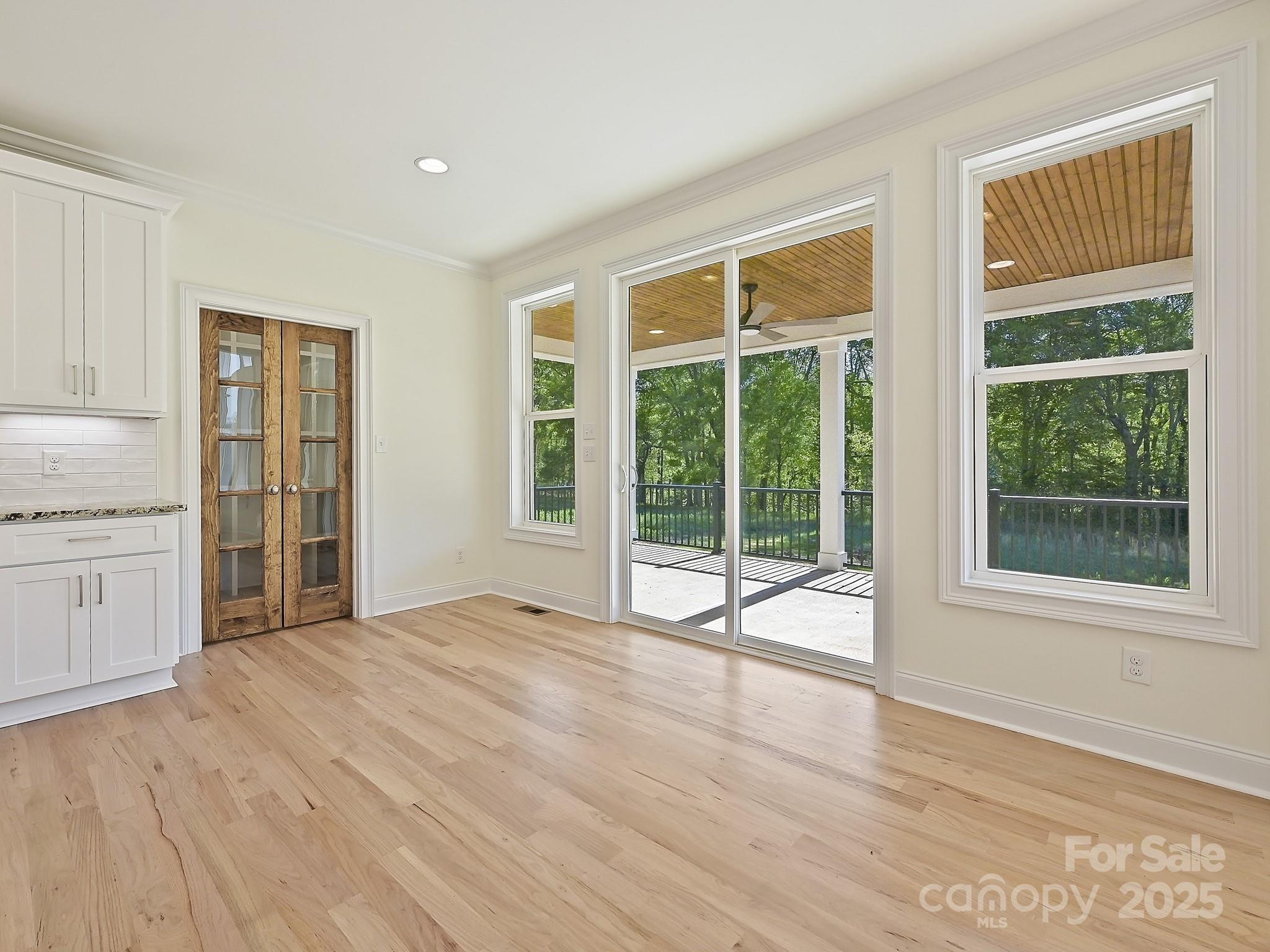 215 Triple Ponds Court Clover, SC 29710 - Photo 13 of 32 a view of an empty room with a window and wooden floor