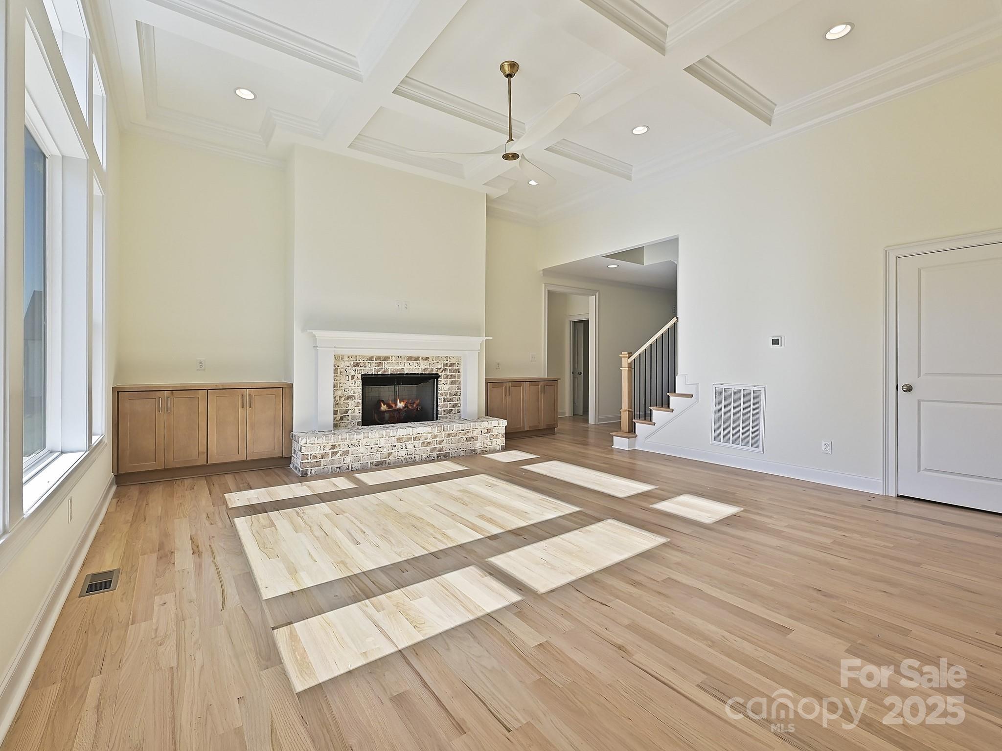 215 Triple Ponds Court Clover, SC 29710 - Photo 16 of 32 an empty room with wooden floor fireplace and windows