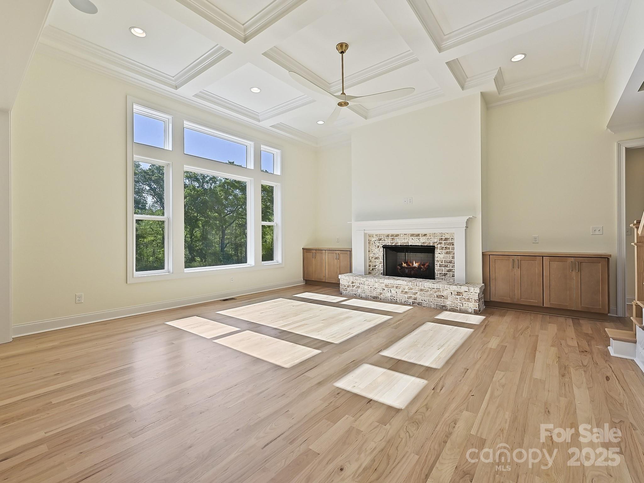 215 Triple Ponds Court Clover, SC 29710 - Photo 17 of 32 a view of an empty room with wooden floor fireplace and a window