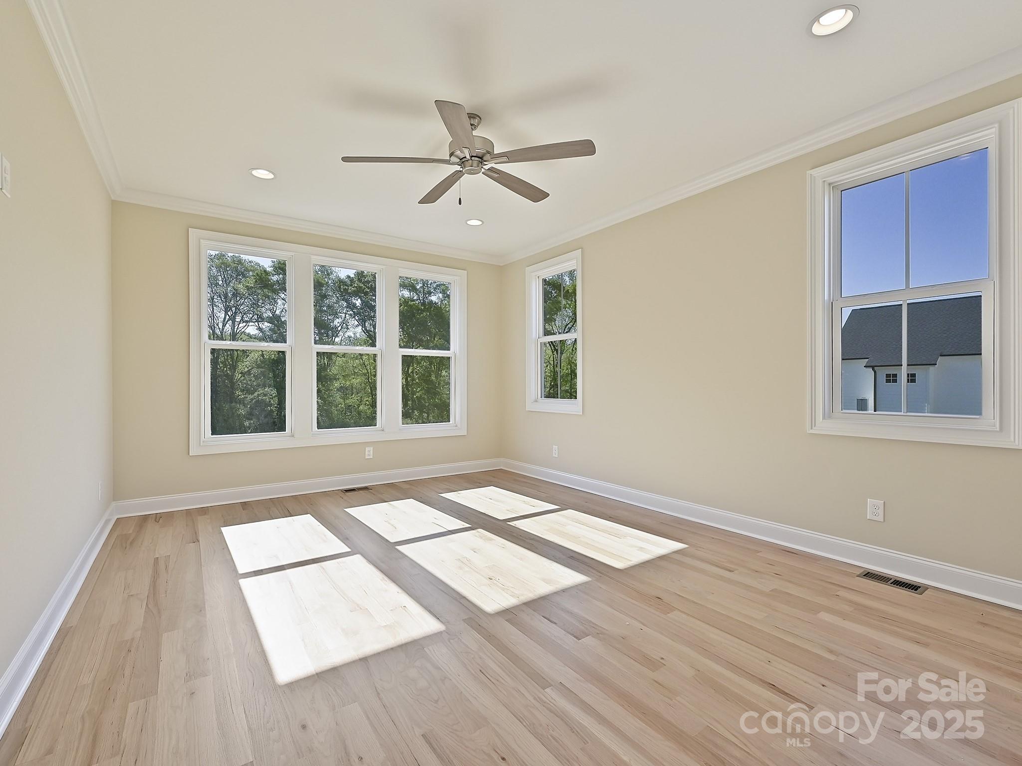 215 Triple Ponds Court Clover, SC 29710 - Photo 18 of 32 a view of an empty room with a window and wooden floor