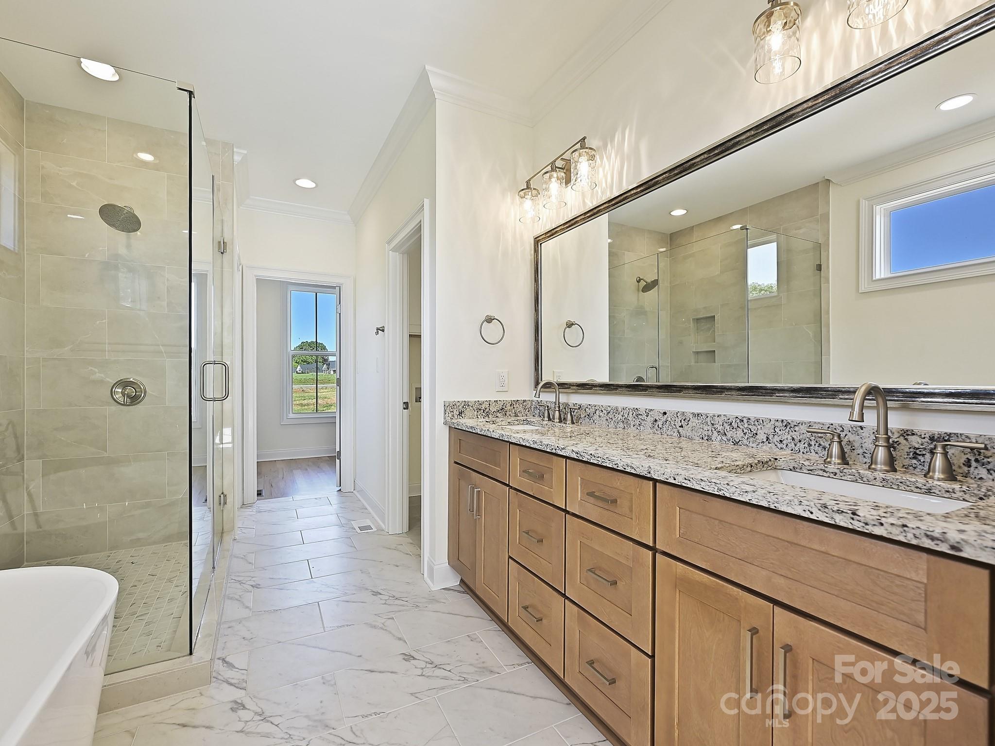 215 Triple Ponds Court Clover, SC 29710 - Photo 20 of 32 a bathroom with a granite countertop sink mirror and shower