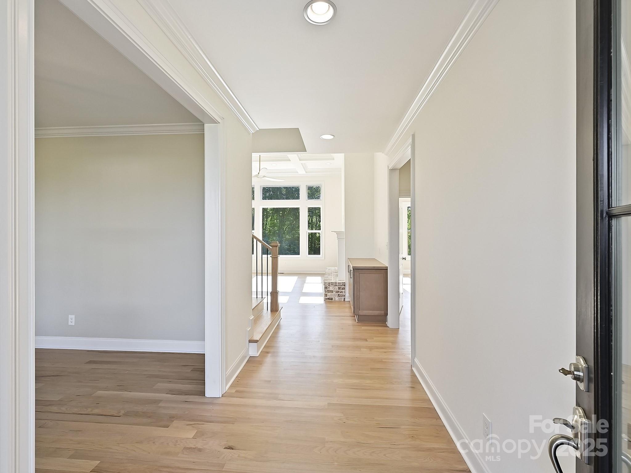 215 Triple Ponds Court Clover, SC 29710 - Photo 2 of 32 a view of a hallway with wooden floor and a living room