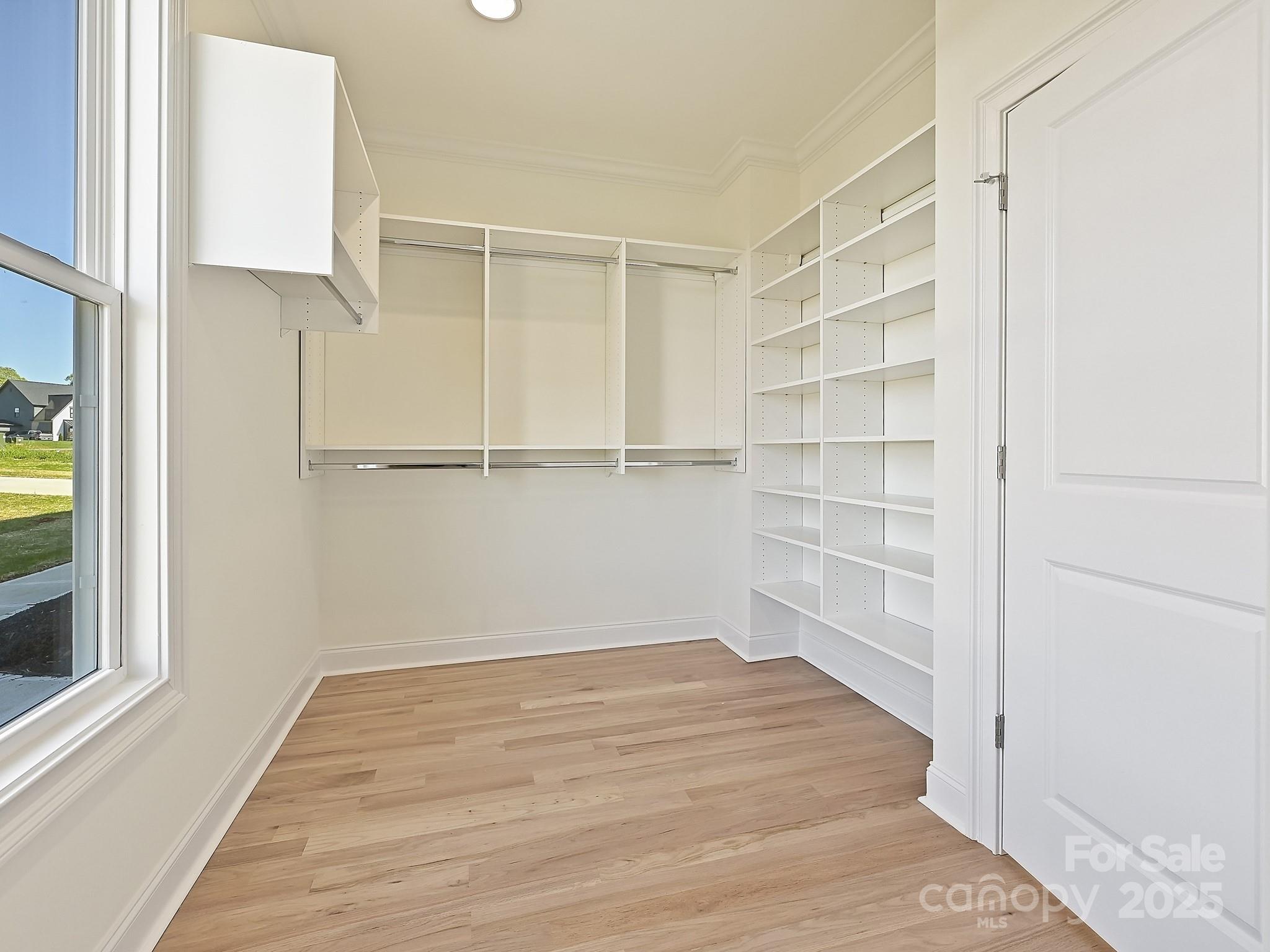 215 Triple Ponds Court Clover, SC 29710 - Photo 23 of 32 a view of an empty room with wooden floor and a window