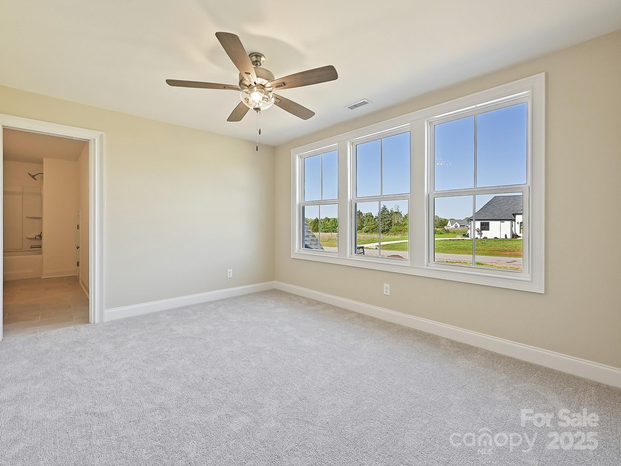 215 Triple Ponds Court Clover, SC 29710 - Photo 25 of 32 an empty room with windows and fan