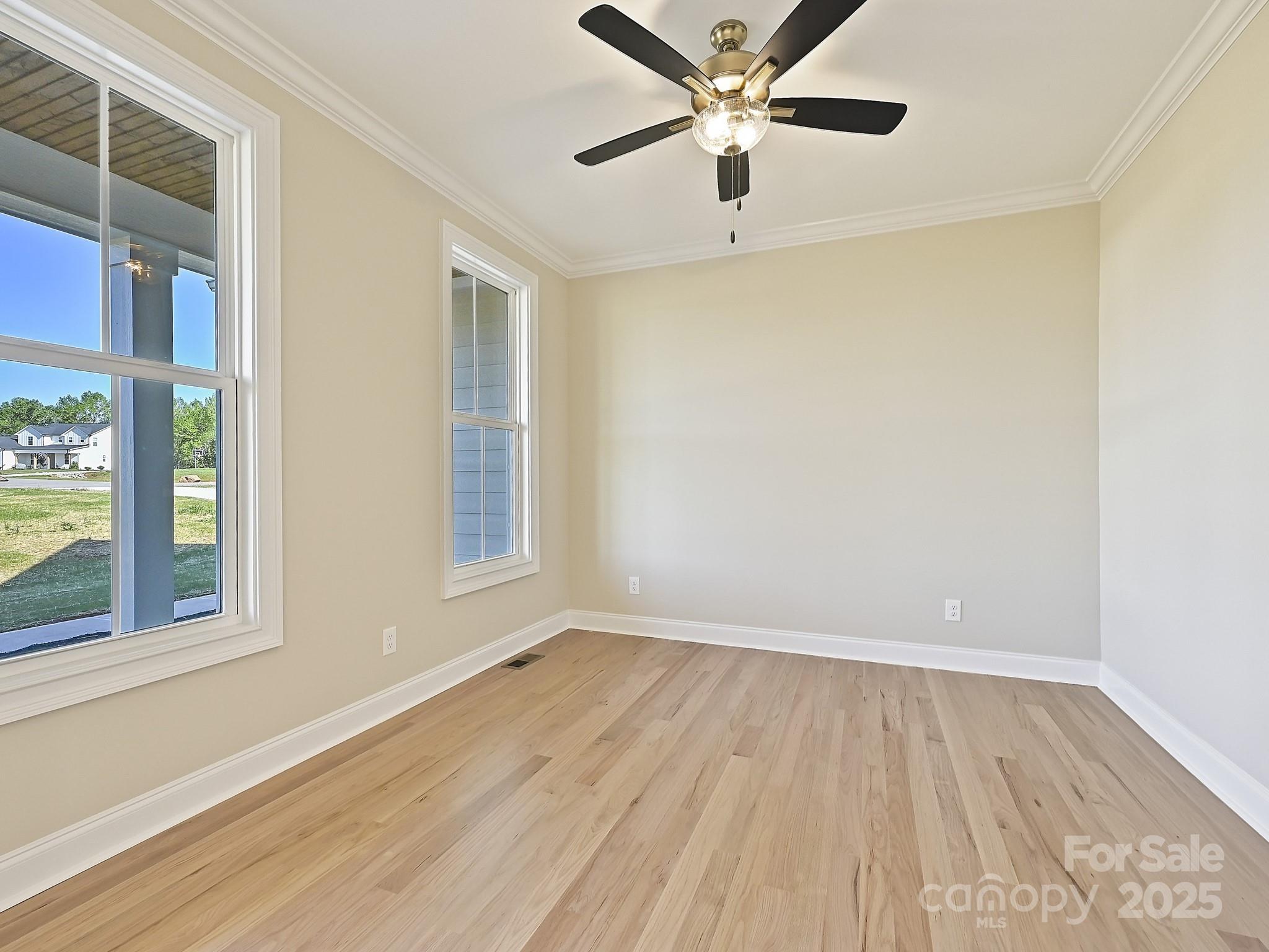 215 Triple Ponds Court Clover, SC 29710 - Photo 4 of 32 a view of an empty room with wooden floor and a window