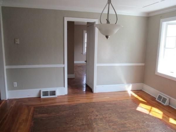 22 Danforth Street Taunton, MA 02780 - Photo 11 of 20 a view of empty room with wooden floor and fan