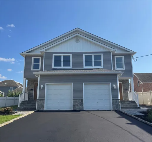 a front view of a house with a garage