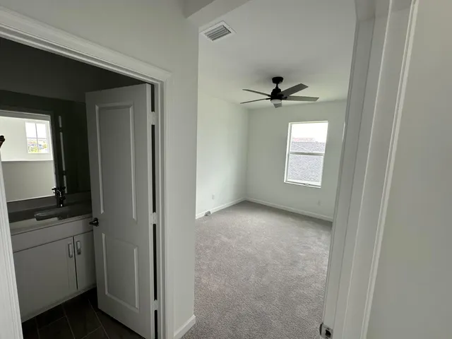 a view of a kitchen with a sink and a window
