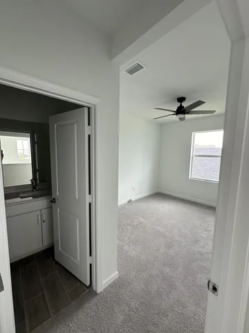 an empty room with a empty space and windows