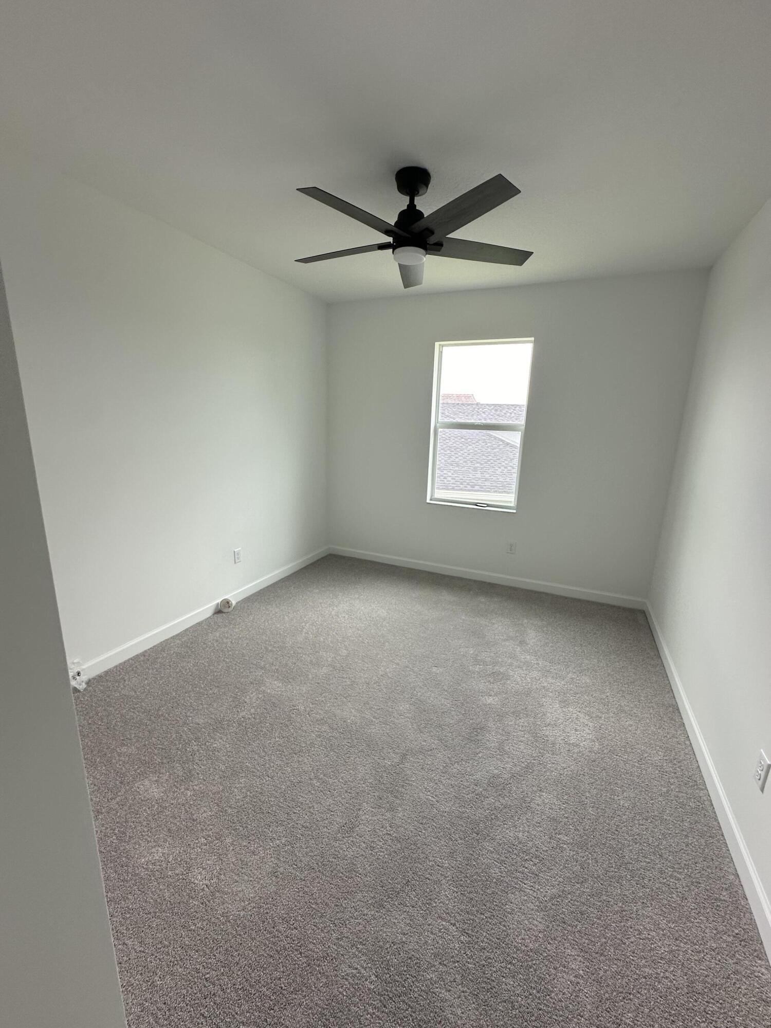 19046 Croft Mill Crossing Loxahatchee, FL 33470 - Photo 16 of 22 an empty room with a window and a fan