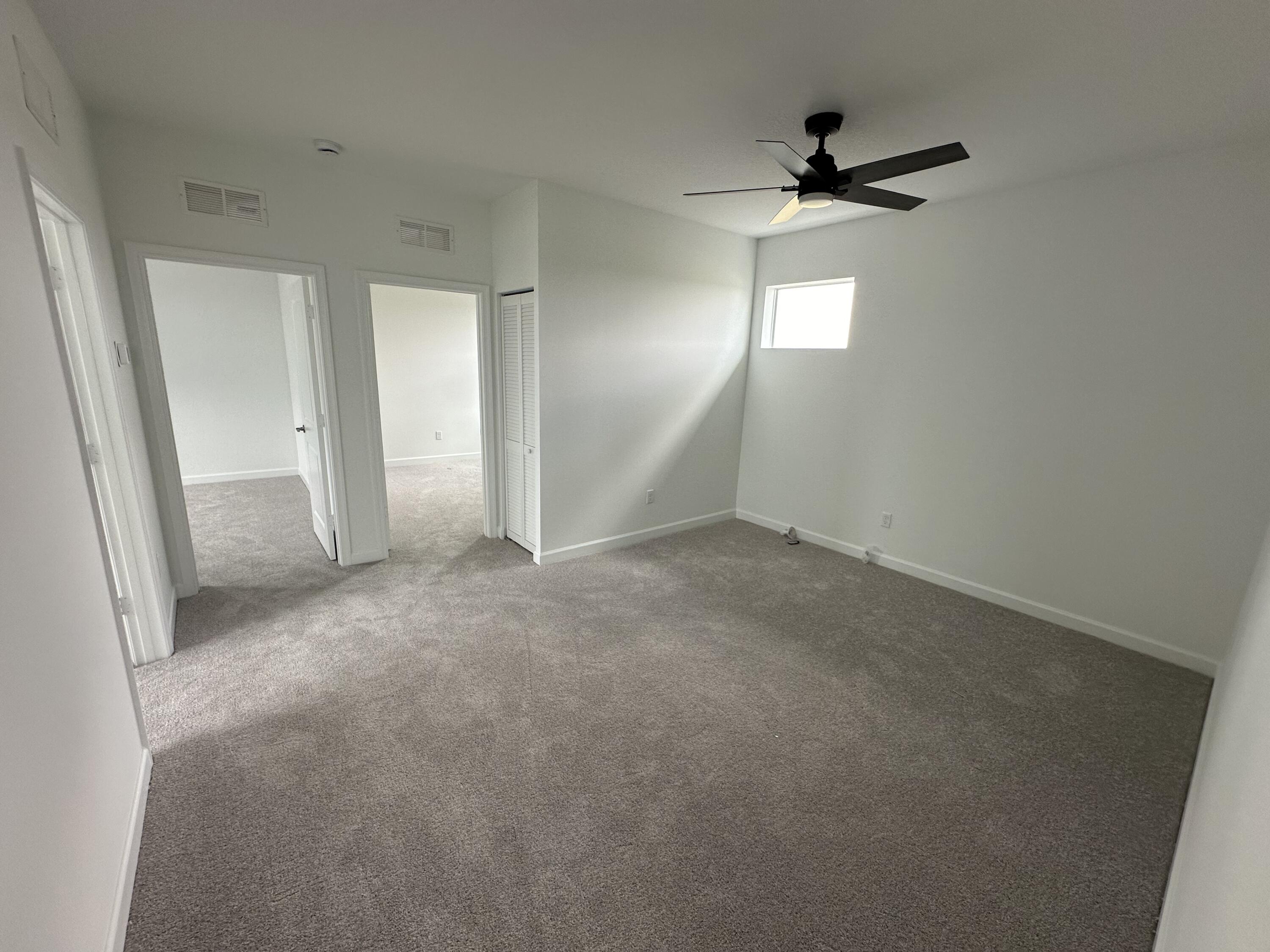 19046 Croft Mill Crossing Loxahatchee, FL 33470 - Photo 19 of 22 en empty room with windows and ceiling fan