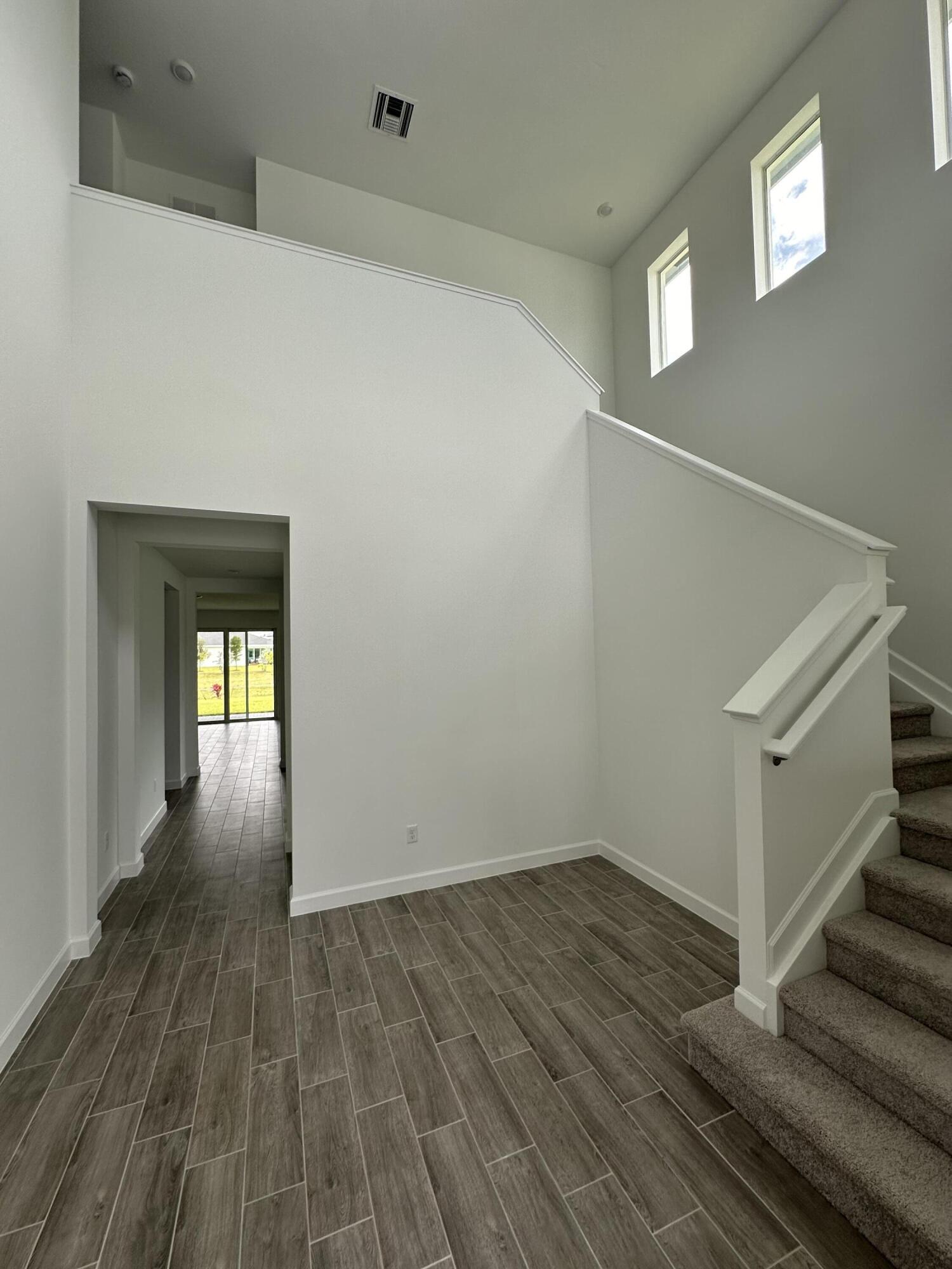 19046 Croft Mill Crossing Loxahatchee, FL 33470 - Photo 3 of 22 a view of a hallway with wooden floor and staircase