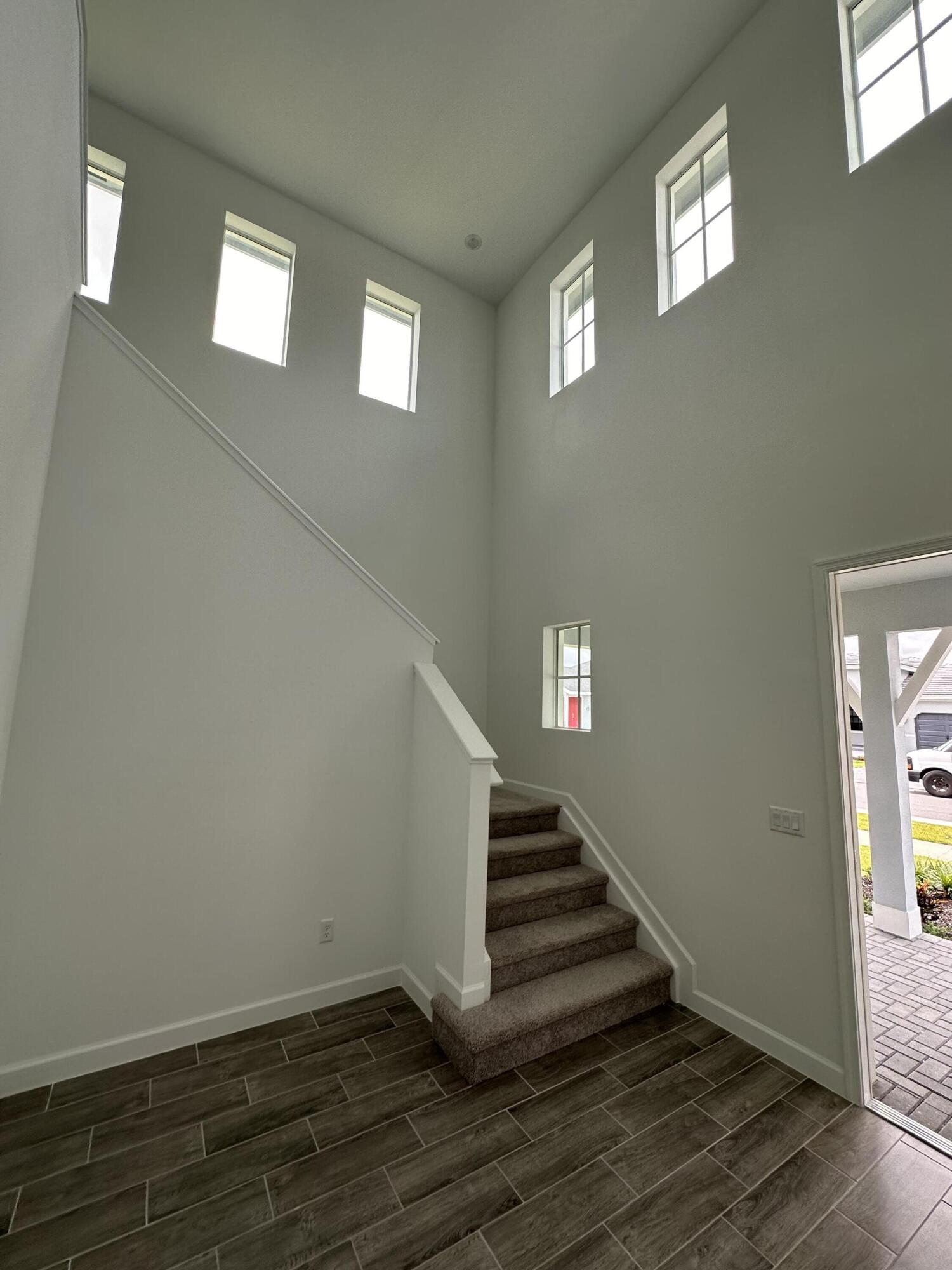 19046 Croft Mill Crossing Loxahatchee, FL 33470 - Photo 4 of 22 a view of a hallway with stairs and wooden floor