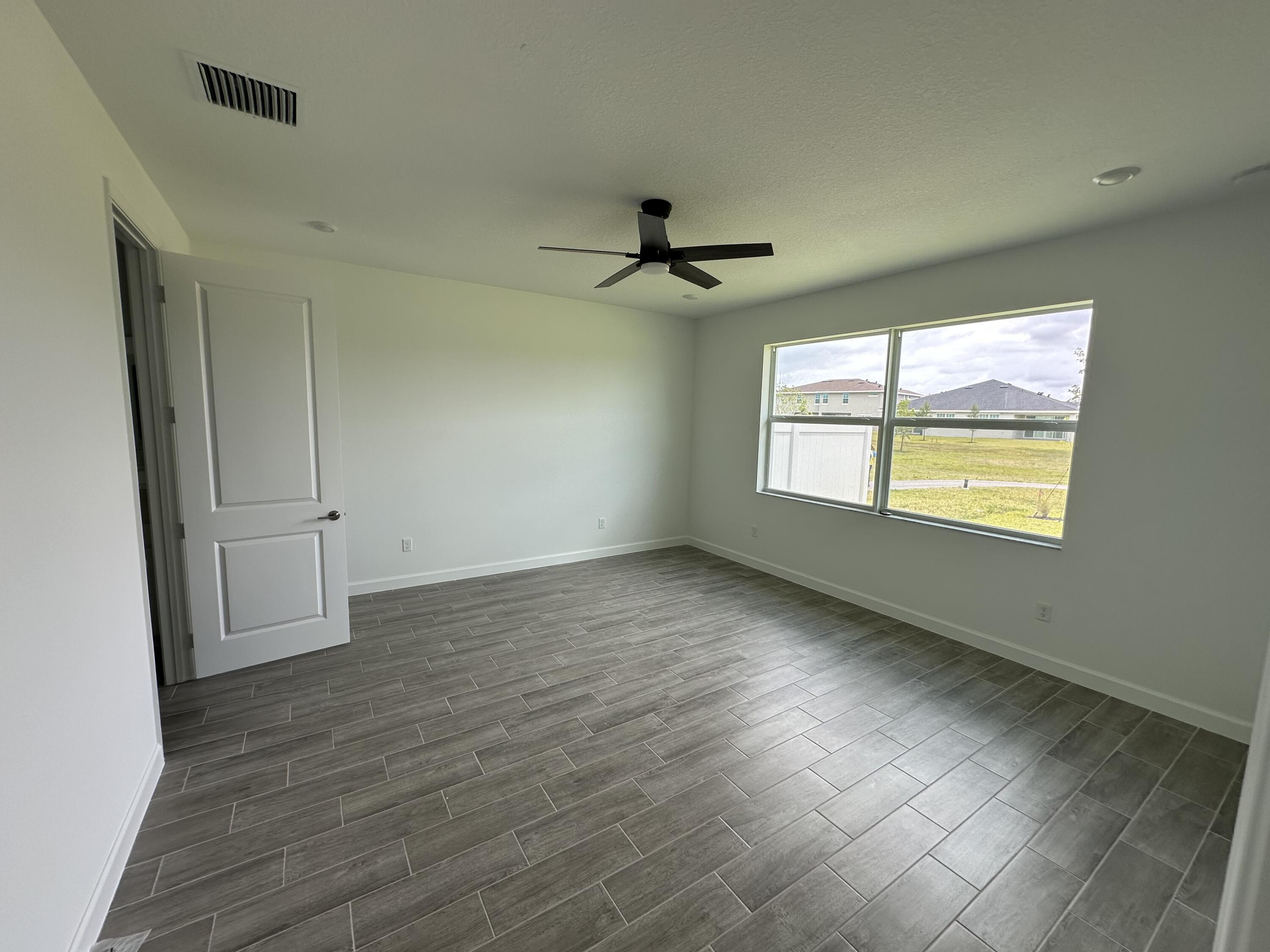 19046 Croft Mill Crossing Loxahatchee, FL 33470 - Photo 10 of 22 a view of an empty room with a window
