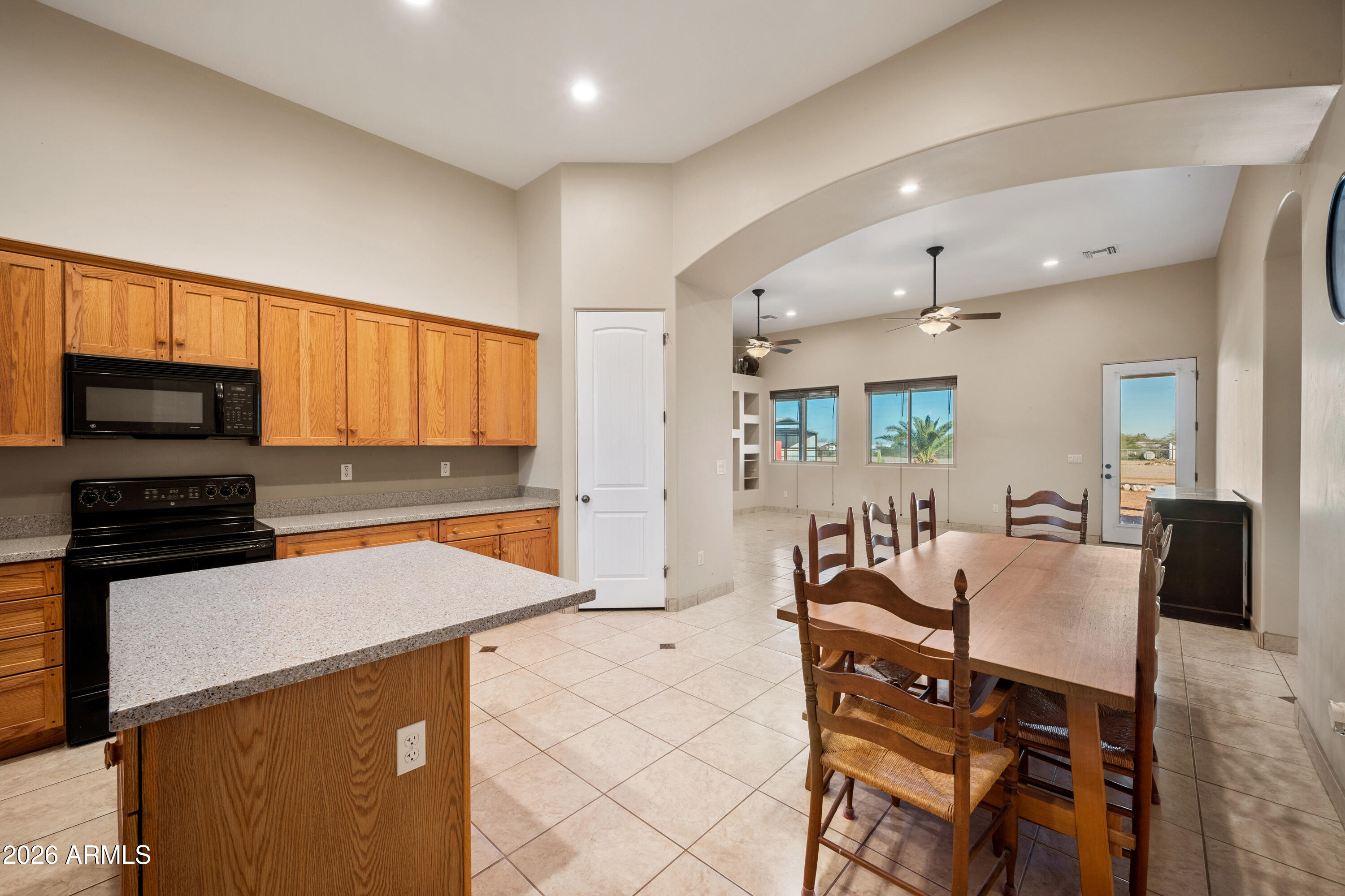 8679 North Warren Road Maricopa, AZ 85139 - Photo 10 of 40 a large kitchen with a table and chairs in it