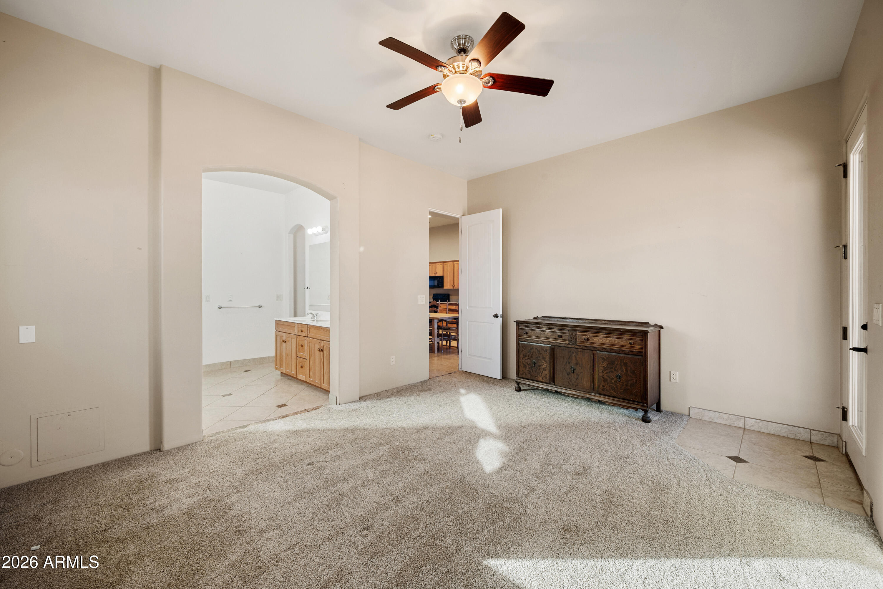 8679 North Warren Road Maricopa, AZ 85139 - Photo 12 of 40 a view of a livingroom with a chandelier fan and a kitchen