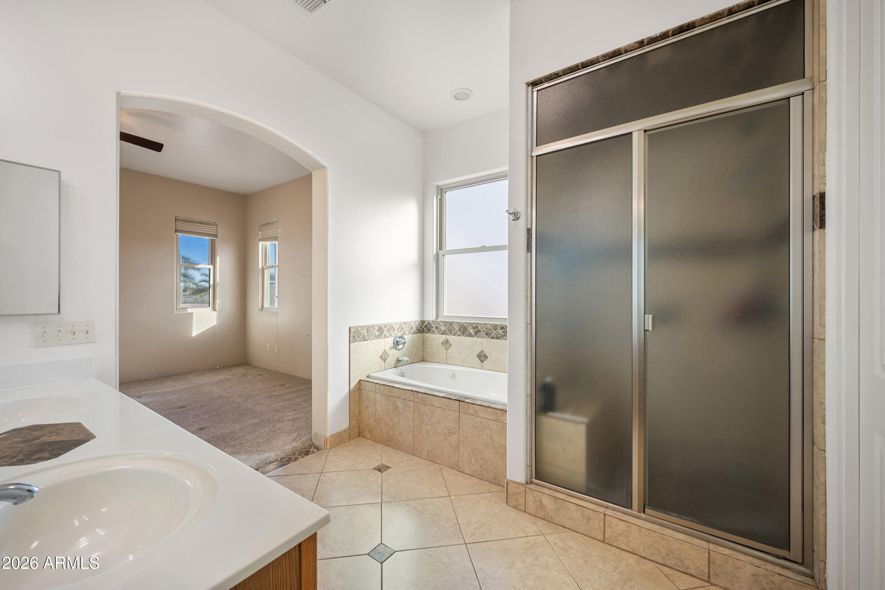 8679 North Warren Road Maricopa, AZ 85139 - Photo 13 of 40 a spacious bathroom with a tub shower and sink