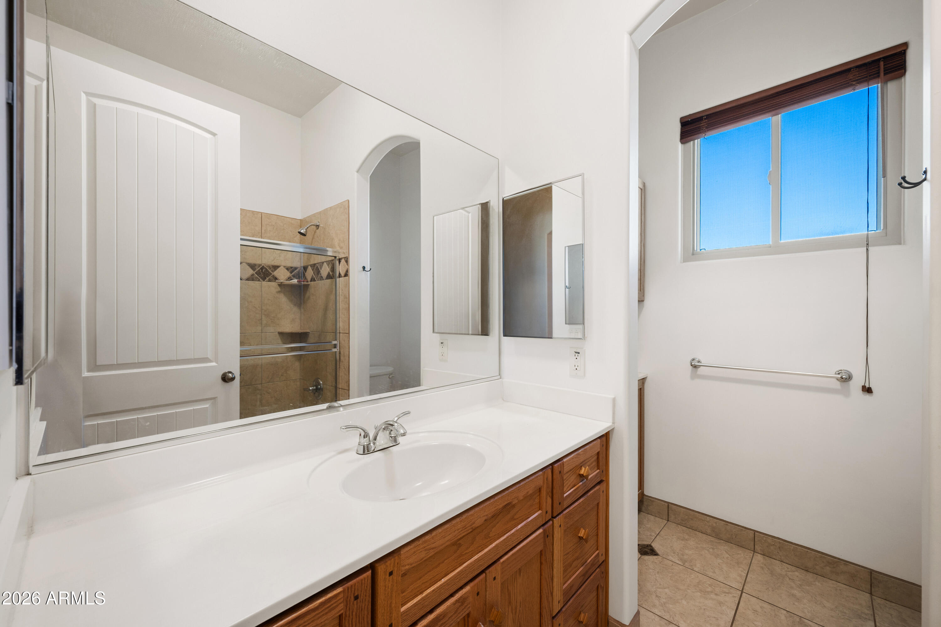 8679 North Warren Road Maricopa, AZ 85139 - Photo 17 of 40 a bathroom with a sink and a mirror