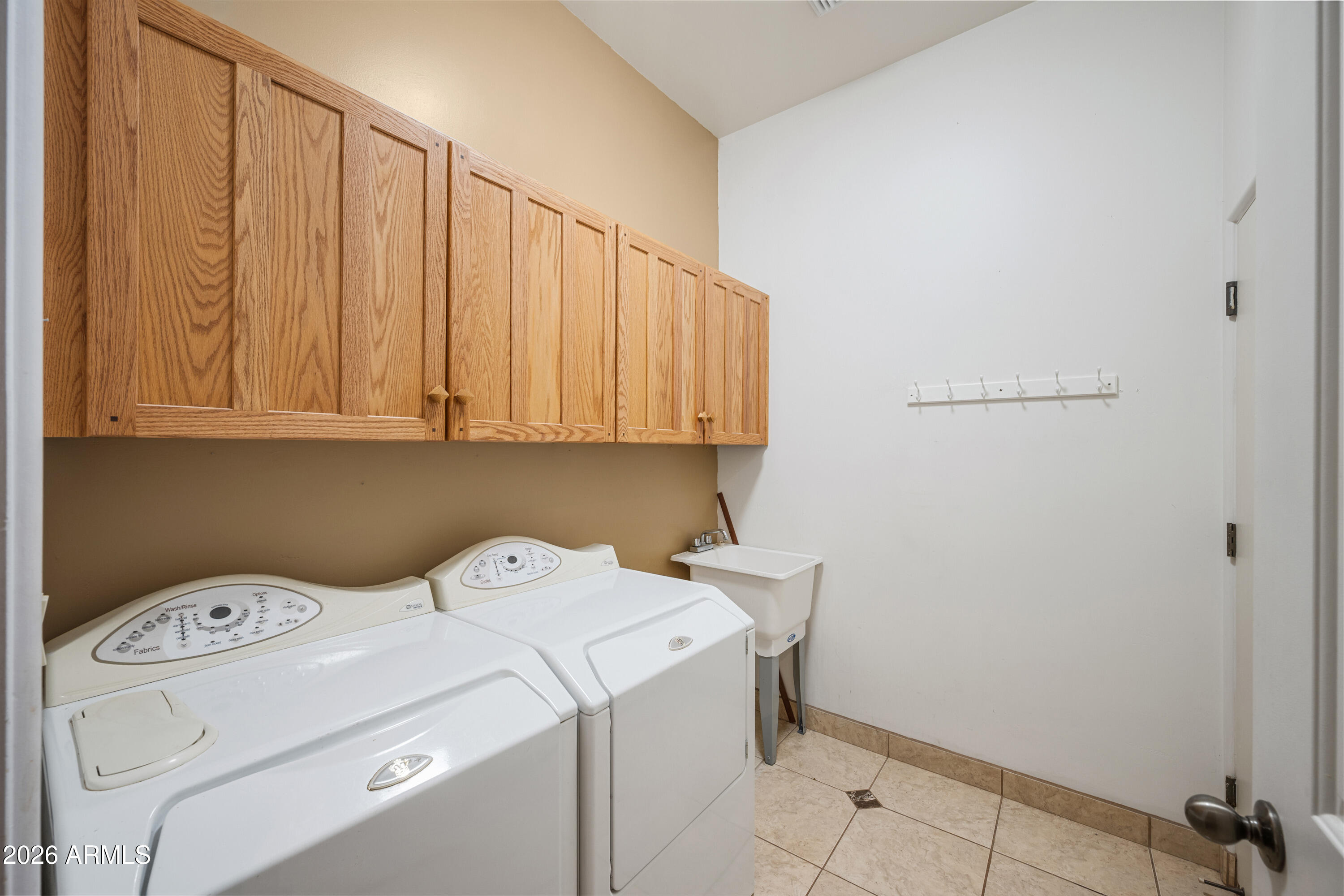 8679 North Warren Road Maricopa, AZ 85139 - Photo 32 of 40 a view of storage and utility room with washer and dryer
