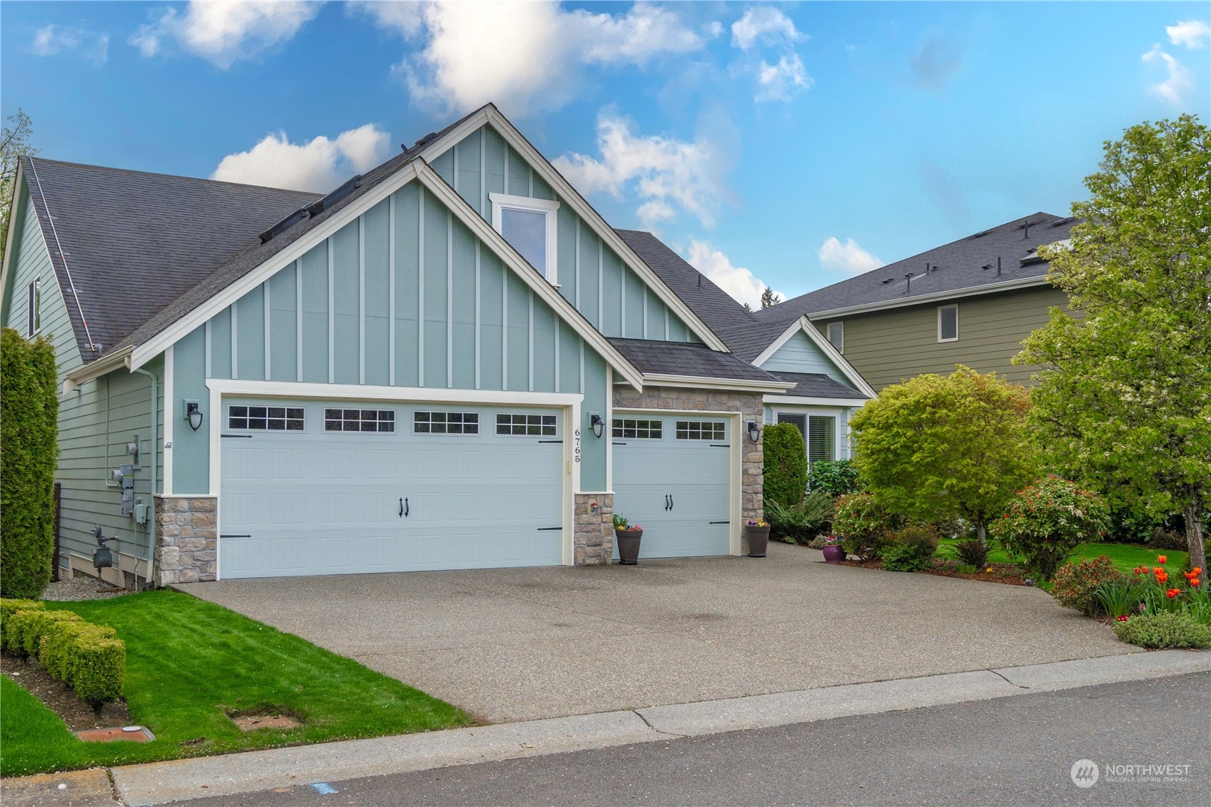 a view of house with backyard and parking