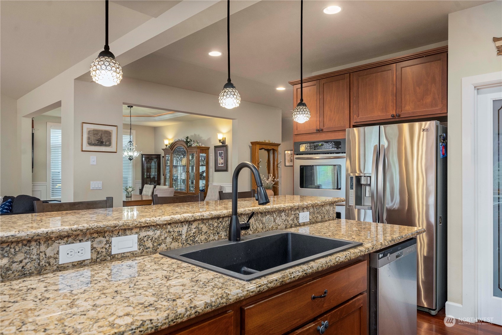 6765 Southeast 2nd Street Renton, WA 98059 - Photo 11 of 36 a kitchen with stainless steel appliances granite countertop a sink a counter space and cabinets