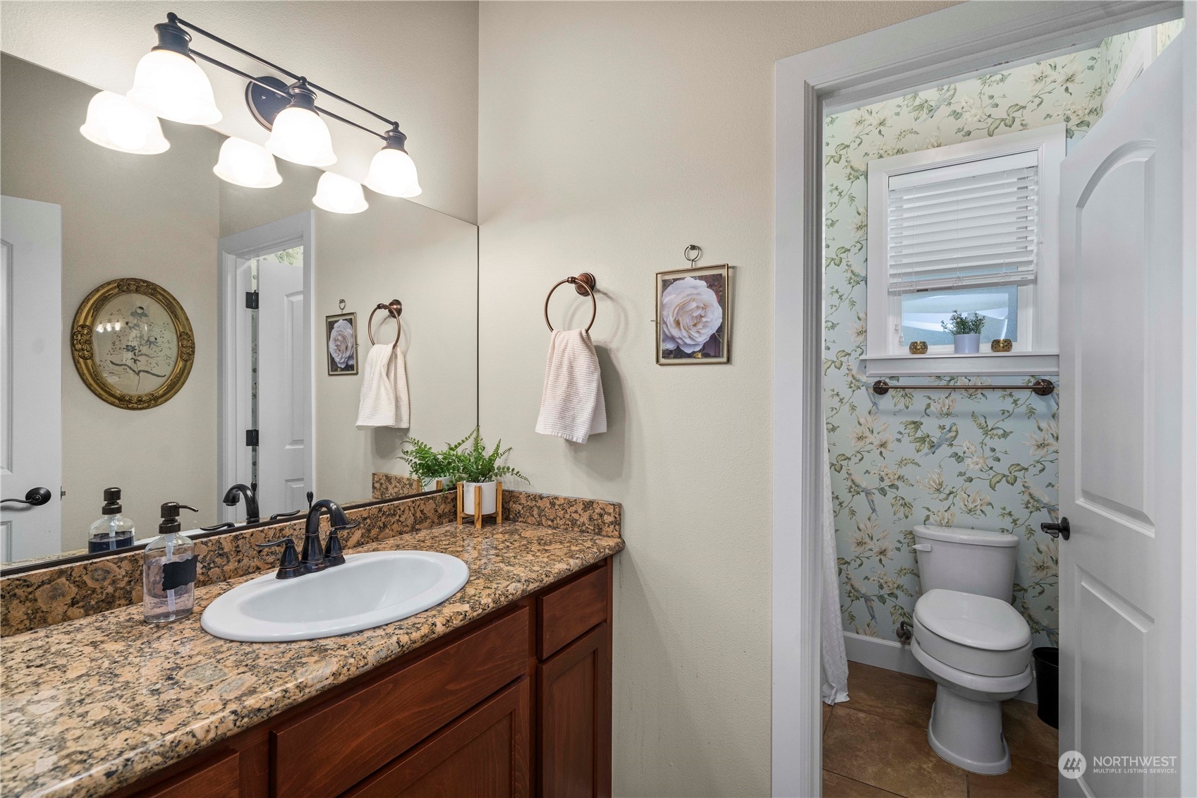 6765 Southeast 2nd Street Renton, WA 98059 - Photo 18 of 36 a bathroom with a granite countertop toilet sink and mirror