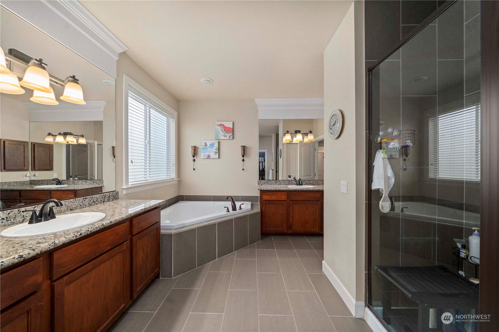 6765 Southeast 2nd Street Renton, WA 98059 - Photo 21 of 36 a large bathroom with a granite countertop double vanity sink a mirror and a bathtub
