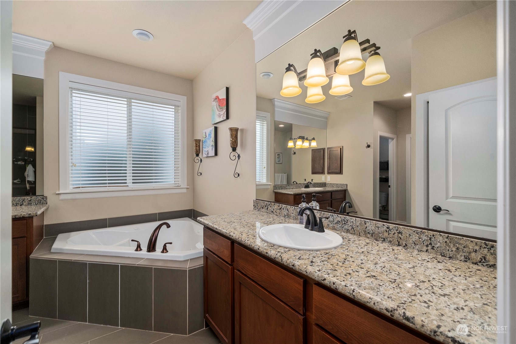 6765 Southeast 2nd Street Renton, WA 98059 - Photo 22 of 36 a bathroom with a granite countertop sink and a mirror