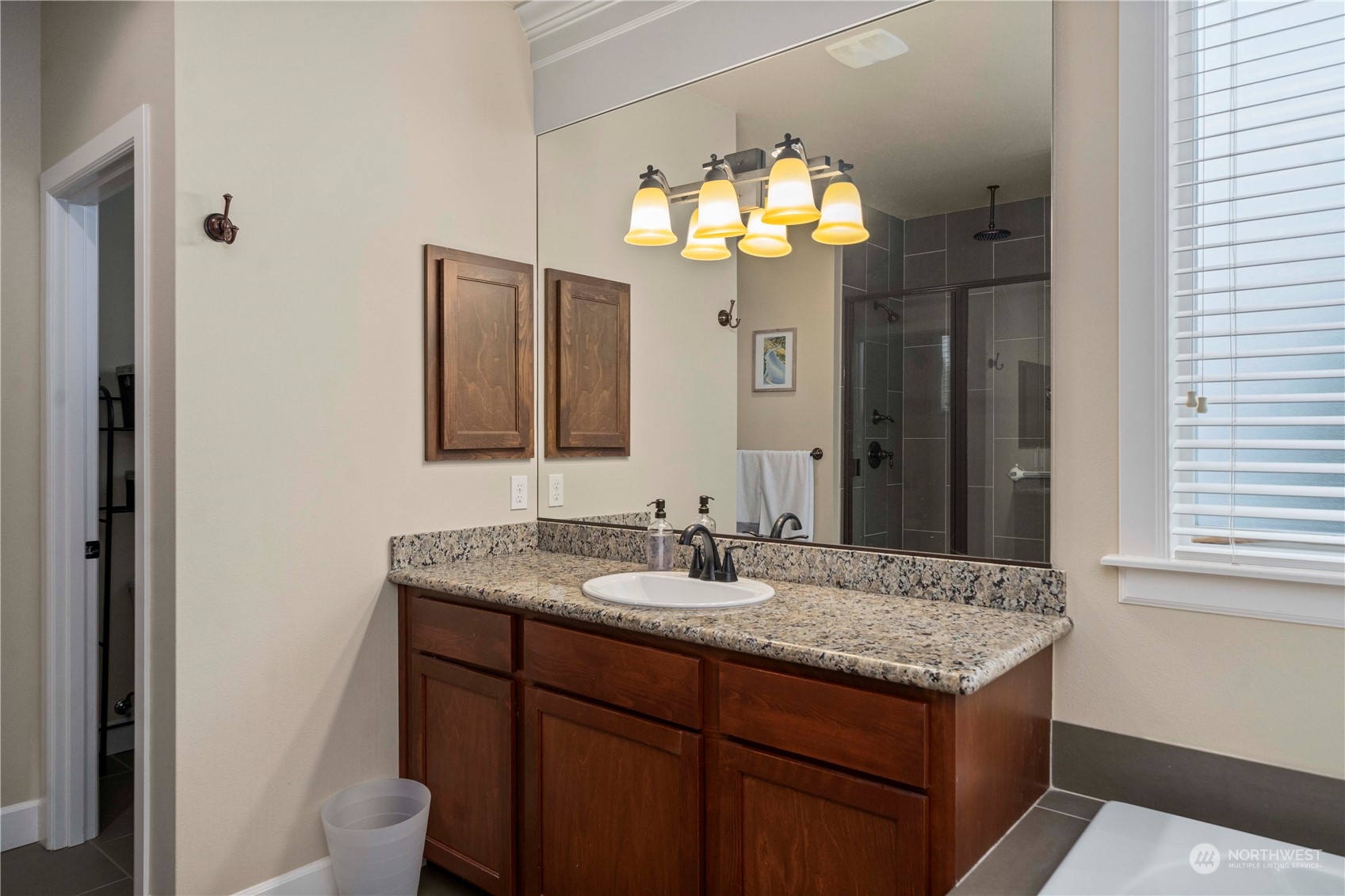 6765 Southeast 2nd Street Renton, WA 98059 - Photo 25 of 36 a bathroom with a granite countertop sink and a mirror
