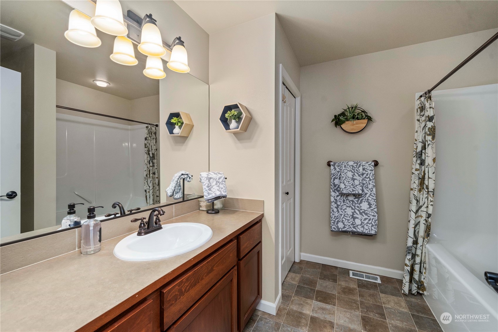 6765 Southeast 2nd Street Renton, WA 98059 - Photo 29 of 36 a bathroom with a sink a mirror and a shower