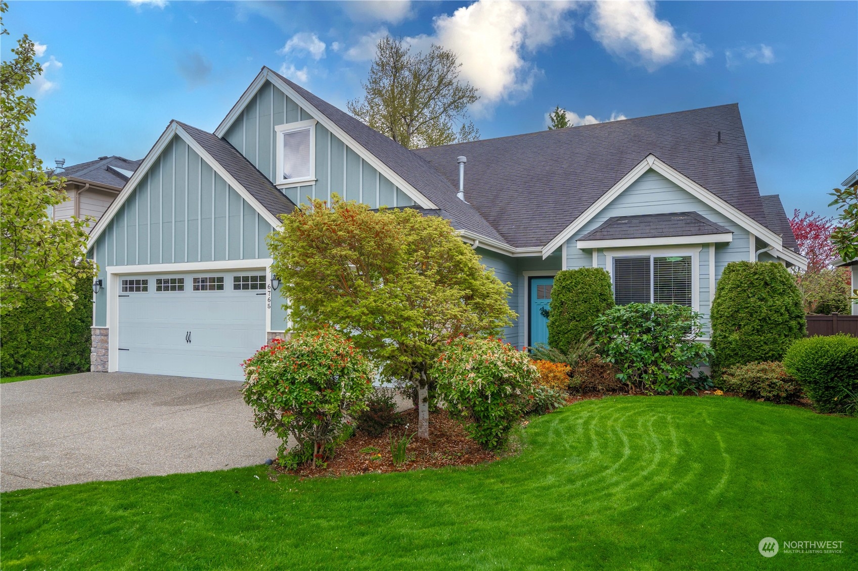 6765 Southeast 2nd Street Renton, WA 98059 - Photo 36 of 36 a front view of a house with a yard and garage