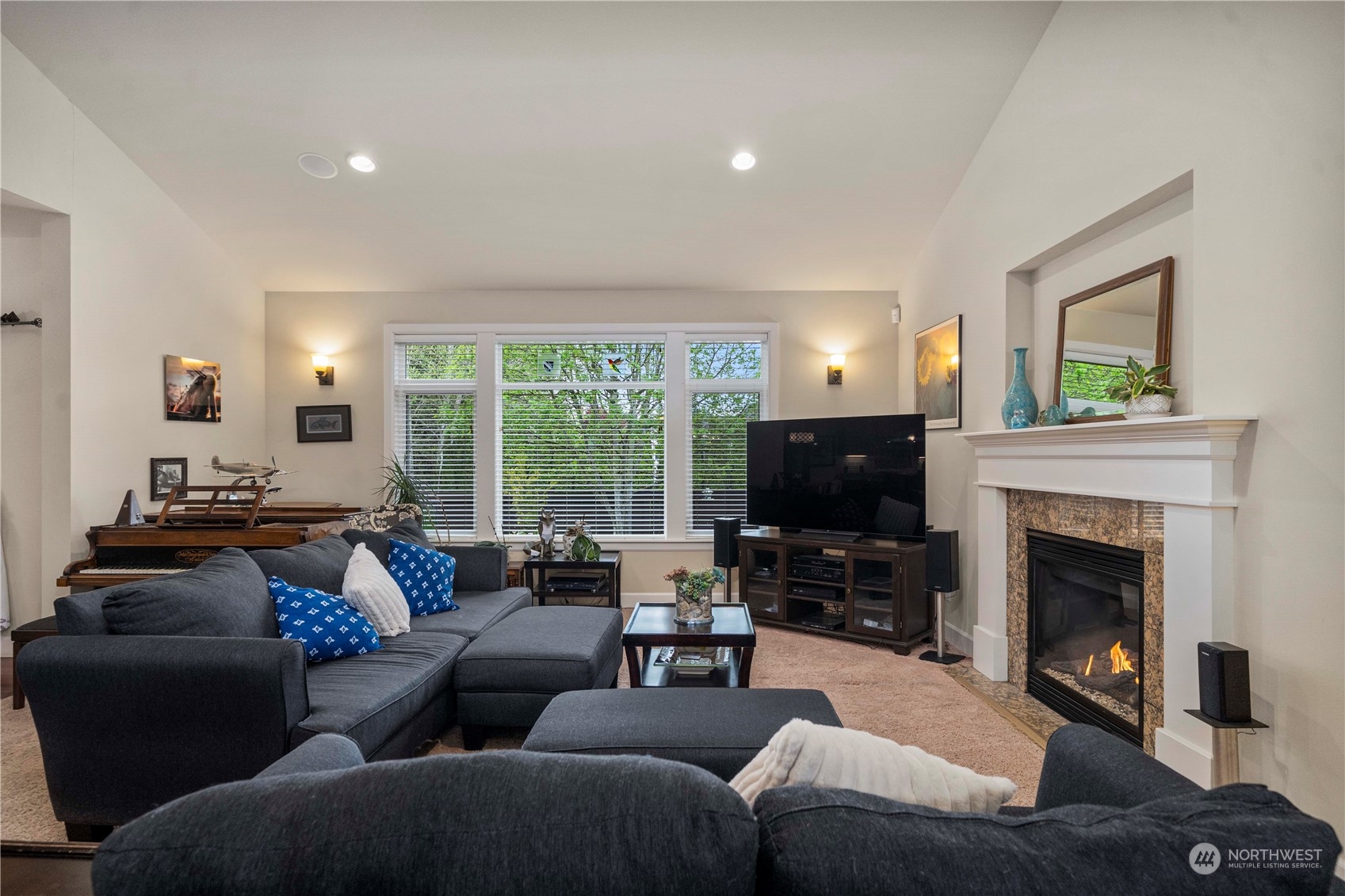 6765 Southeast 2nd Street Renton, WA 98059 - Photo 4 of 36 a living room with furniture a flat screen tv and a fireplace
