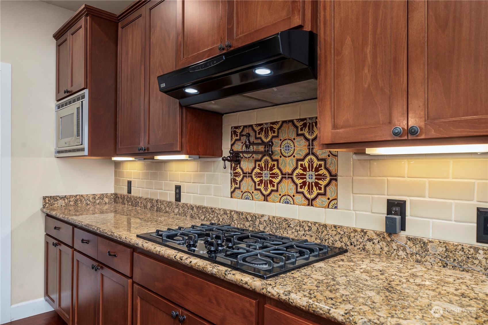 6765 Southeast 2nd Street Renton, WA 98059 - Photo 10 of 36 a kitchen with wooden cabinets and a stove top oven
