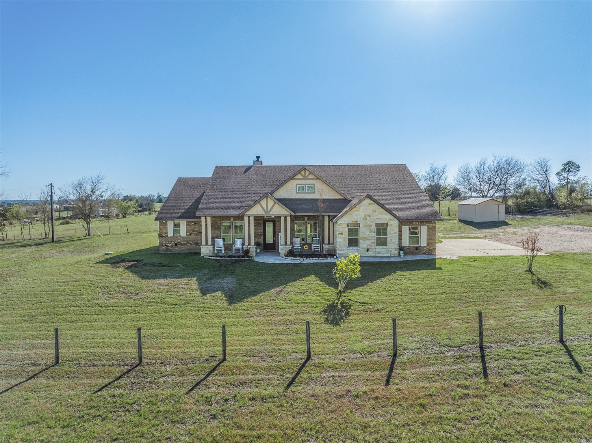 1813 Cemetery Road Bellville, TX 77418 - Photo 1 of 27 a front view of a house with garden