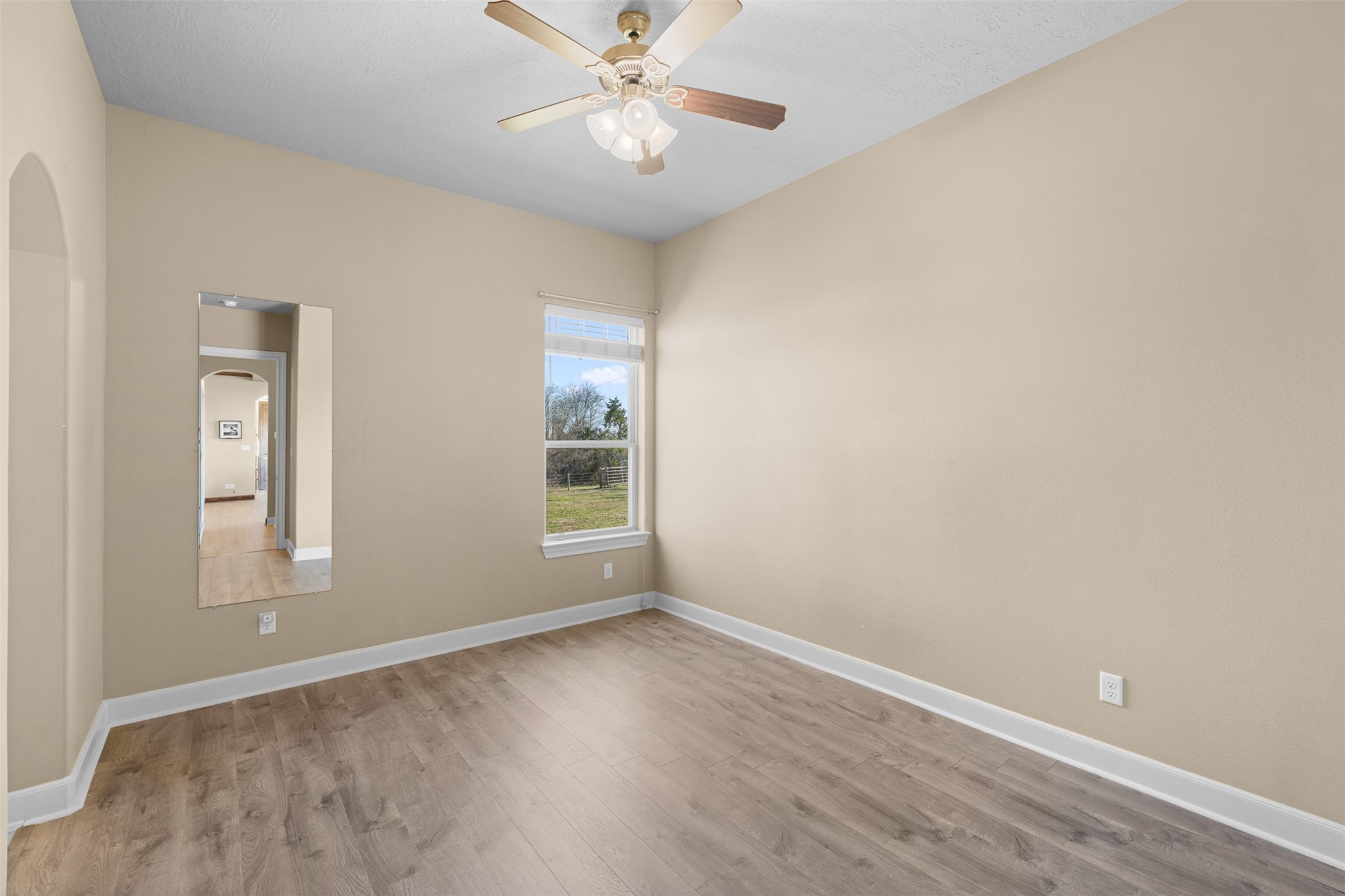 1813 Cemetery Road Bellville, TX 77418 - Photo 18 of 27 wooden floor in an empty room with a window