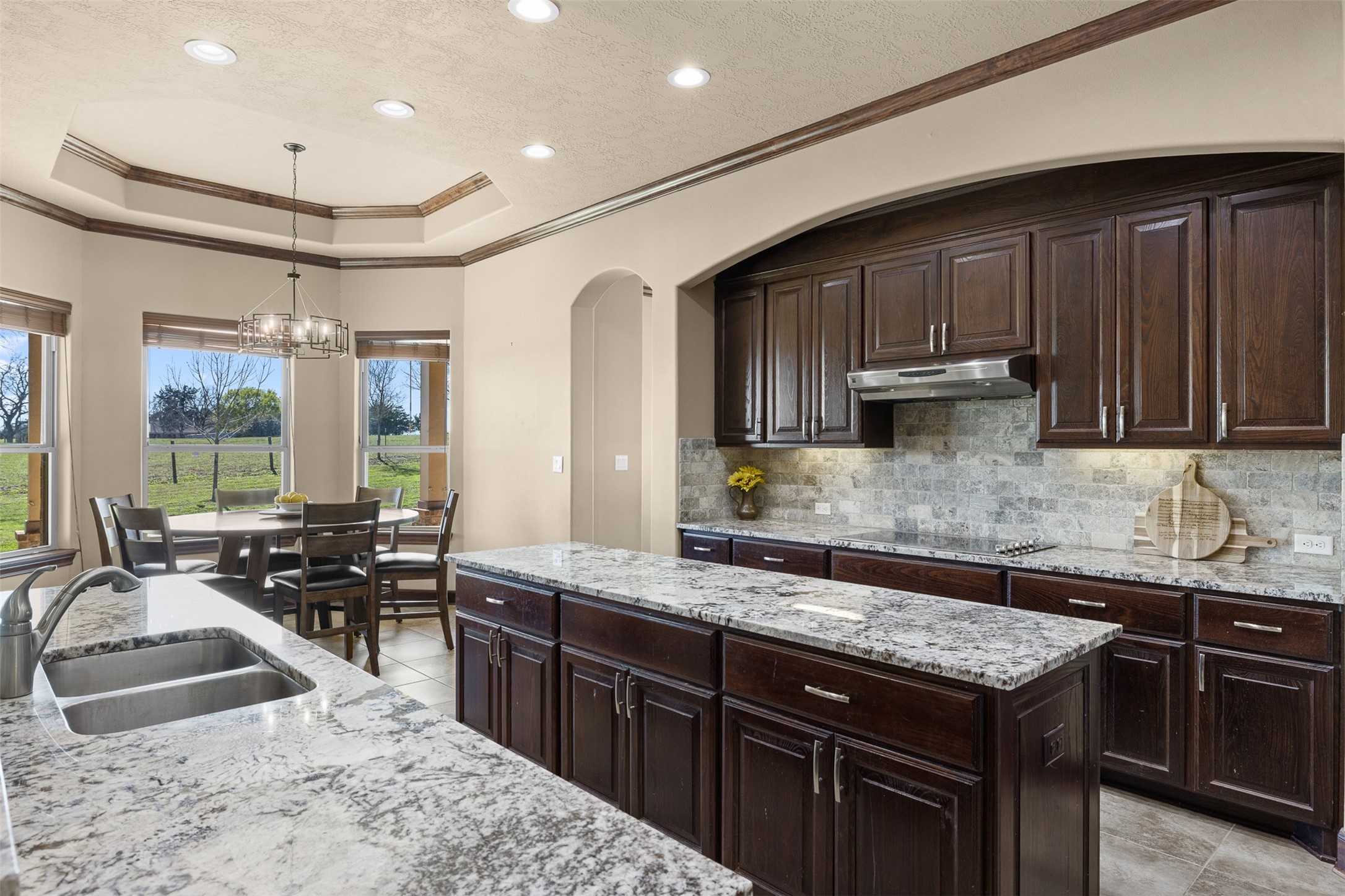 1813 Cemetery Road Bellville, TX 77418 - Photo 7 of 26 a kitchen with stainless steel appliances granite countertop a sink stove and cabinets