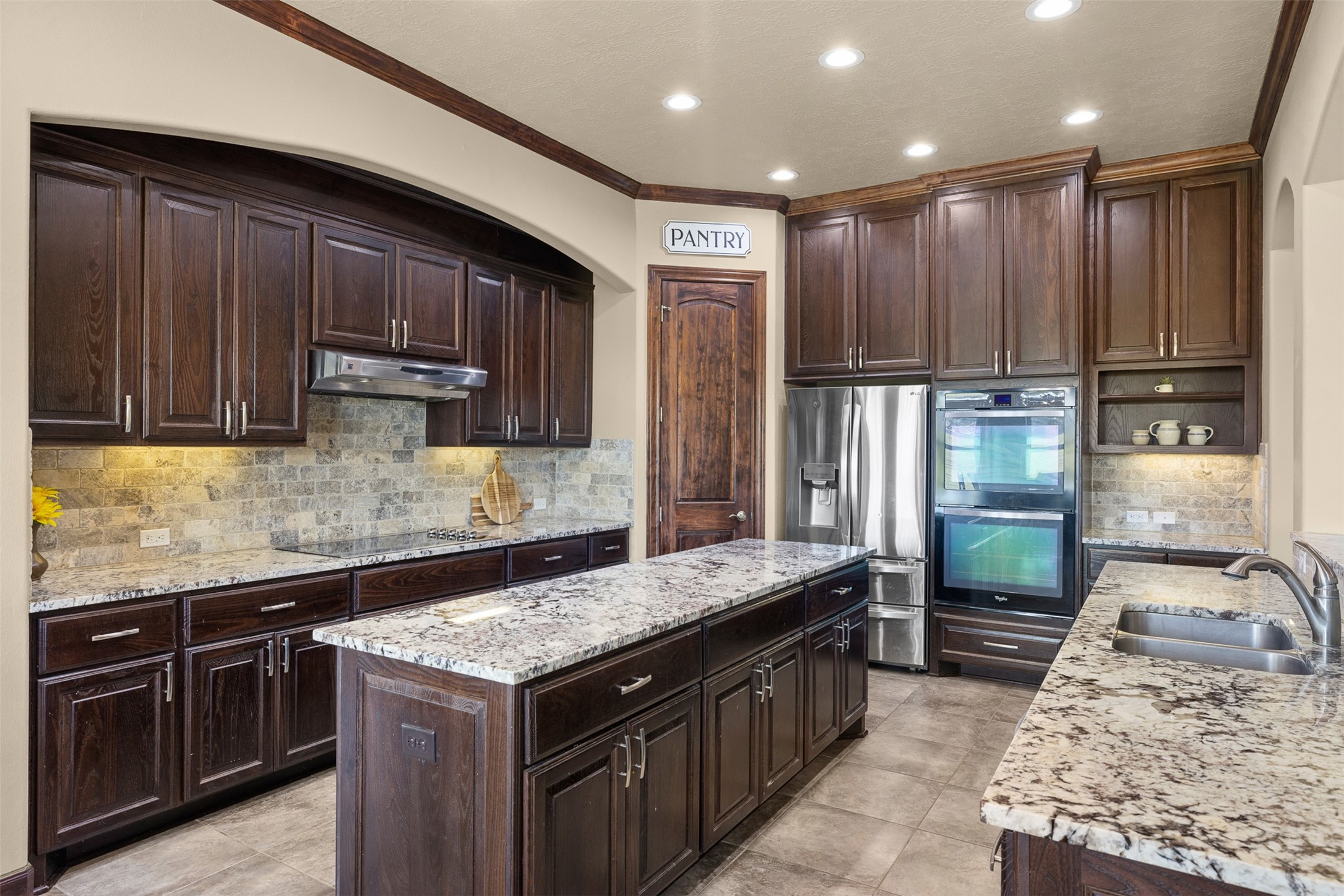 1813 Cemetery Road Bellville, TX 77418 - Photo 9 of 27 a kitchen with granite countertop stainless steel appliances and wooden cabinets