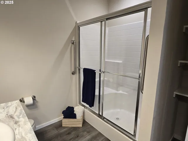 a bathroom with a glass shower door