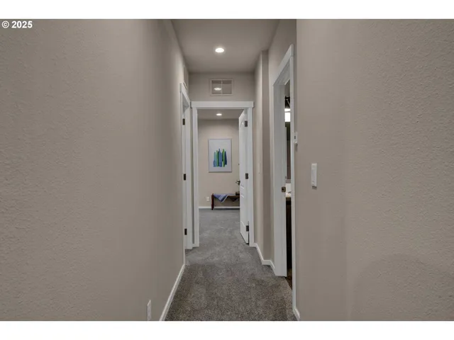 a view of a hallway with wooden shelves