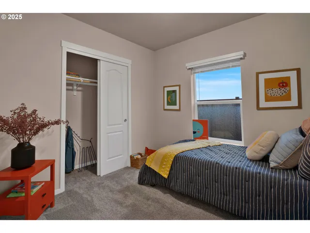 a bedroom with a bed and a potted plant