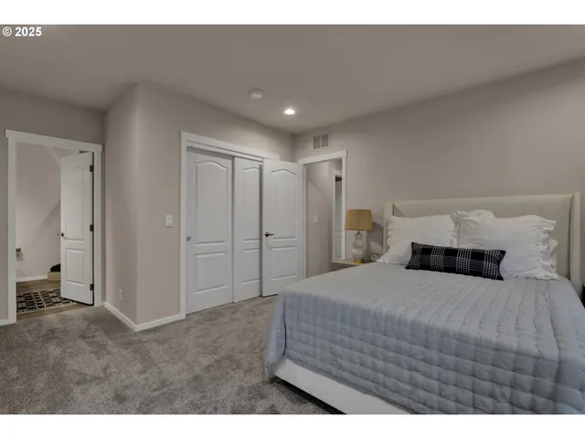 a bedroom with a bed and a view of closet