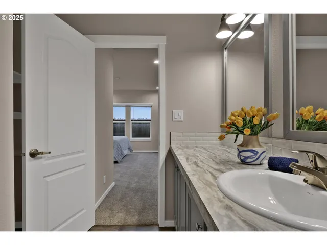 a bathroom with a granite countertop sink a toilet and a mirror