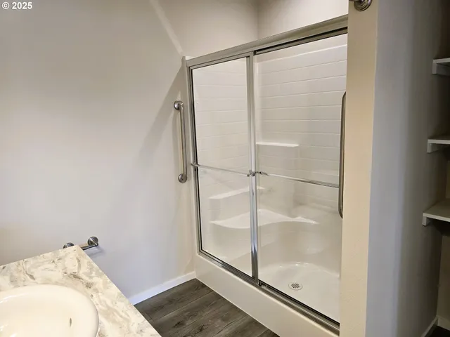 a bathroom with a glass shower door