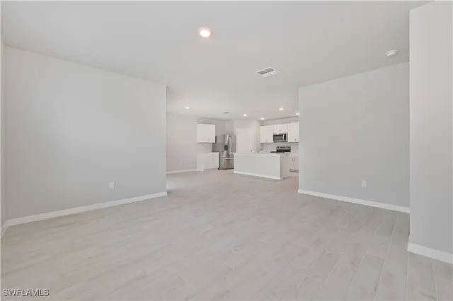a view of a kitchen with a sink and cabinets
