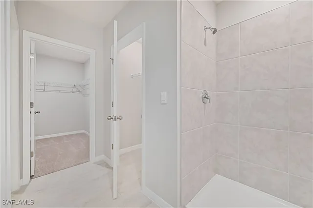 a bathroom with a glass shower door