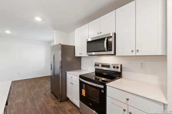a kitchen with stainless steel appliances a stove microwave and refrigerator