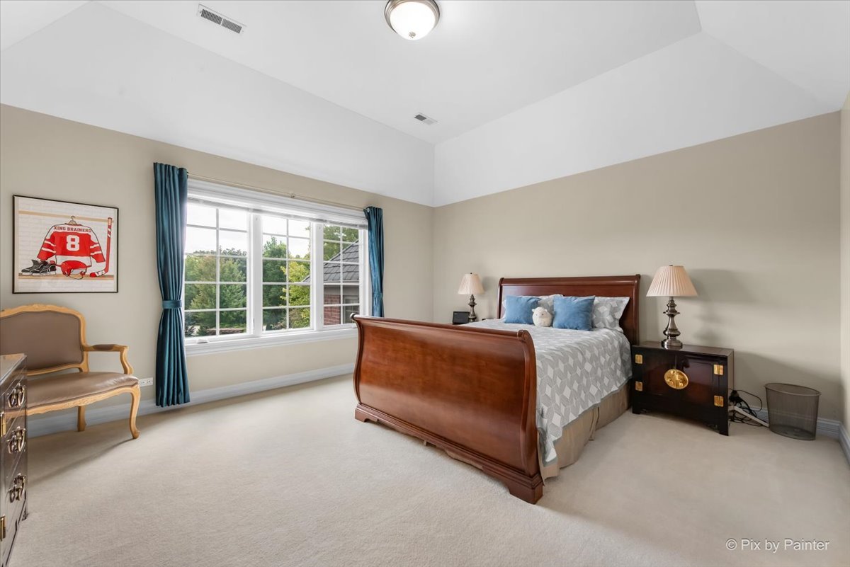 36W535 Hunters Gate Road St. Charles, IL 60175 - Photo 42 of 56 a spacious bedroom with a bed couch and a window